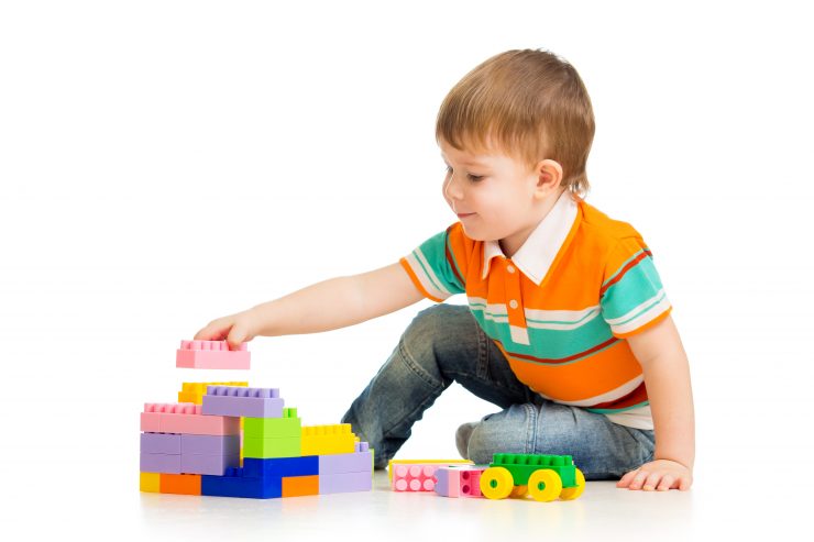 cute child boy with construction set over white background